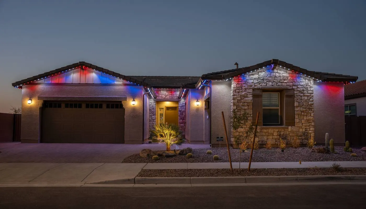 The same desert home lit in red, white, and blue for Independence Day